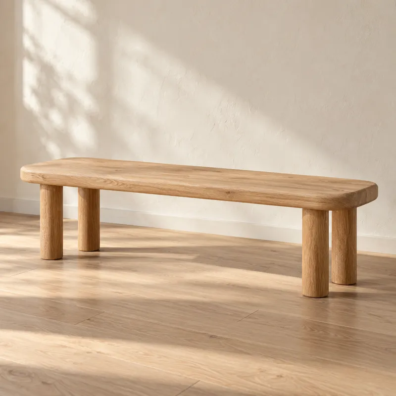 Solid oak bench in soft sunlight against a warm plaster wall